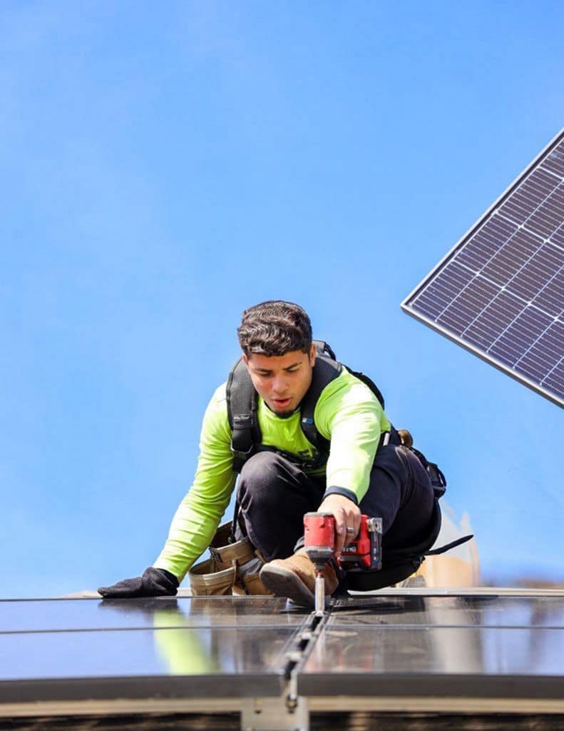 Certified solar technician working on a roof