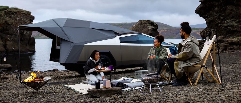 family camping by a tesla cybertruck