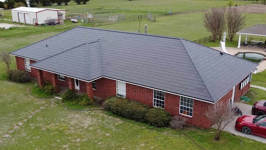 big red house powered by Tesla solar roof