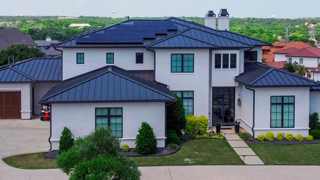 Metal roofed house with Tesla Solar Panels on top