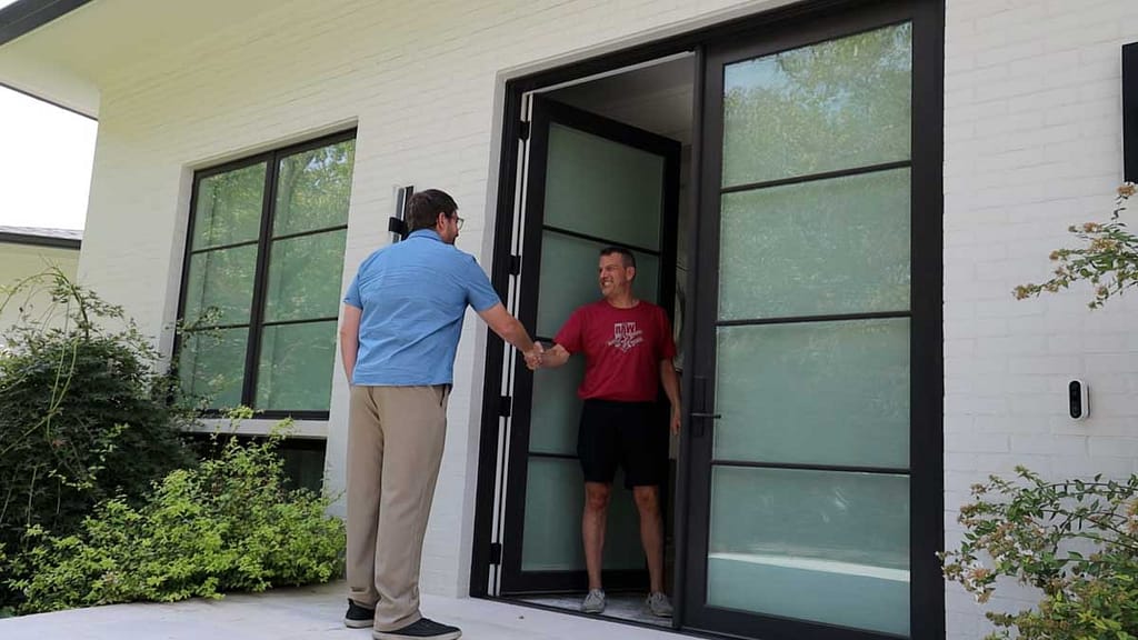 solar company employee greeting a customer