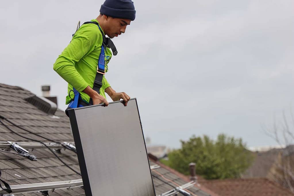 solar installer holding solar panel