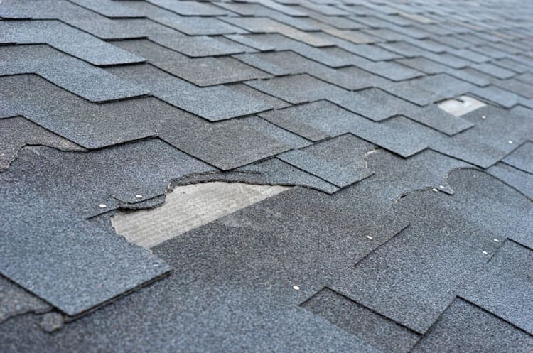 broken asphalt shingles on roof