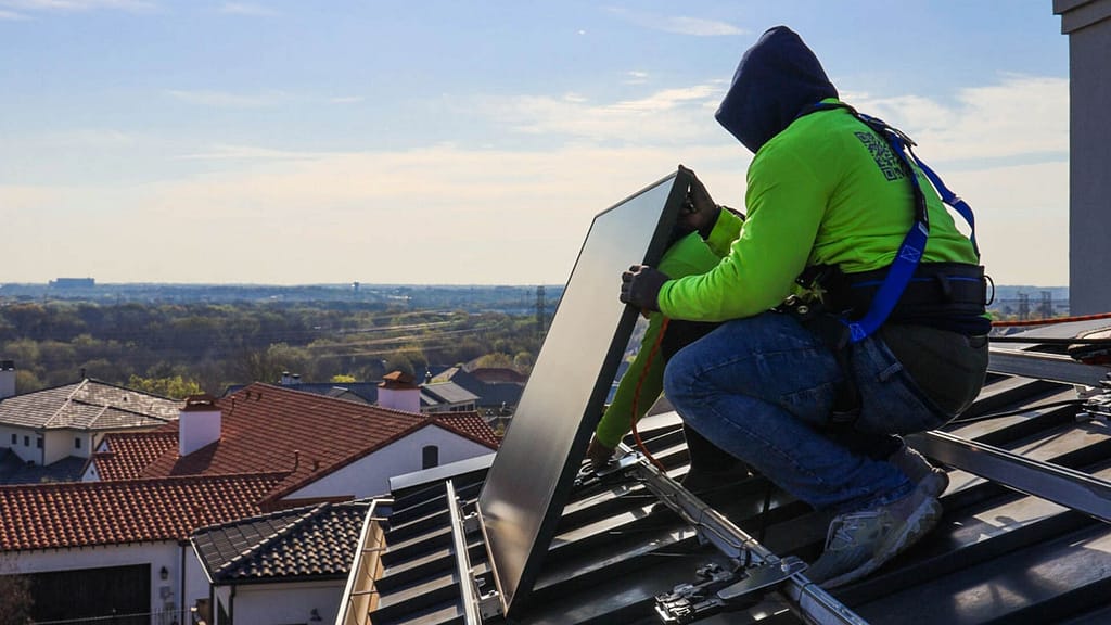 person installing a solar panel