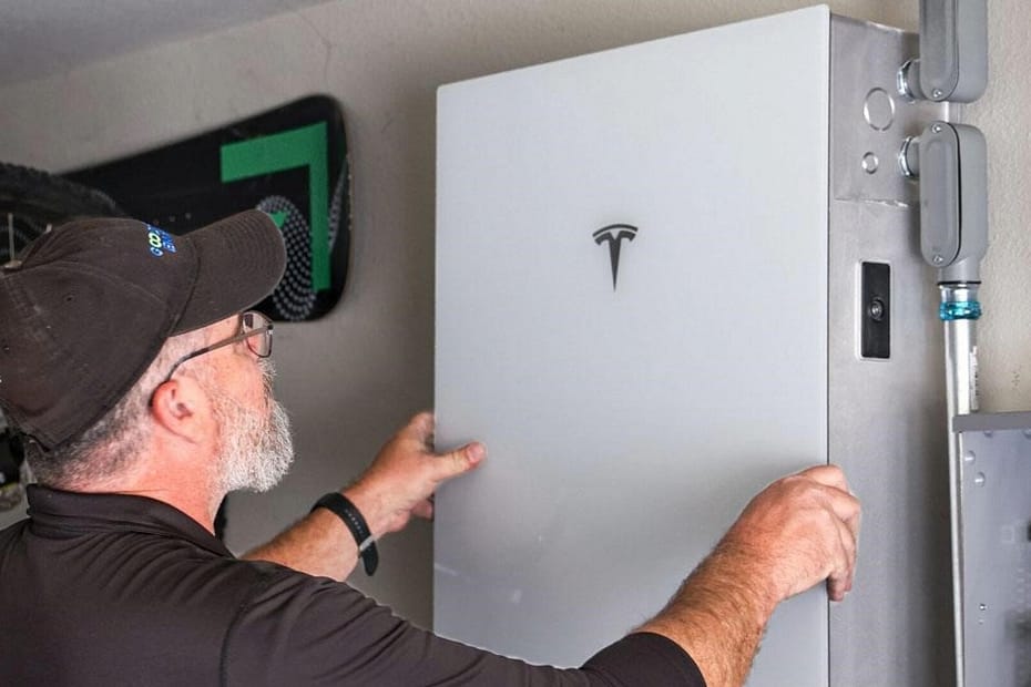 person installing a tesla powerwall