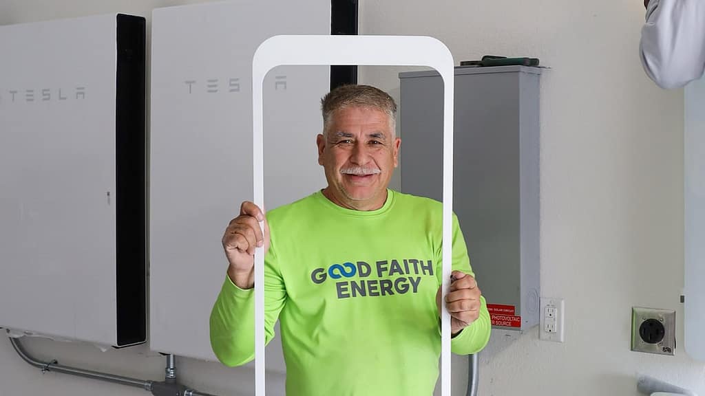 Good Faith Energy staff holding white frame