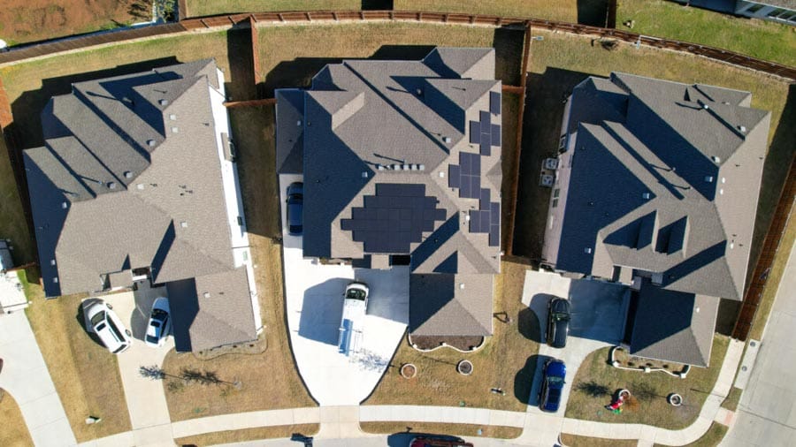 bird's eye view of solar panels on homes