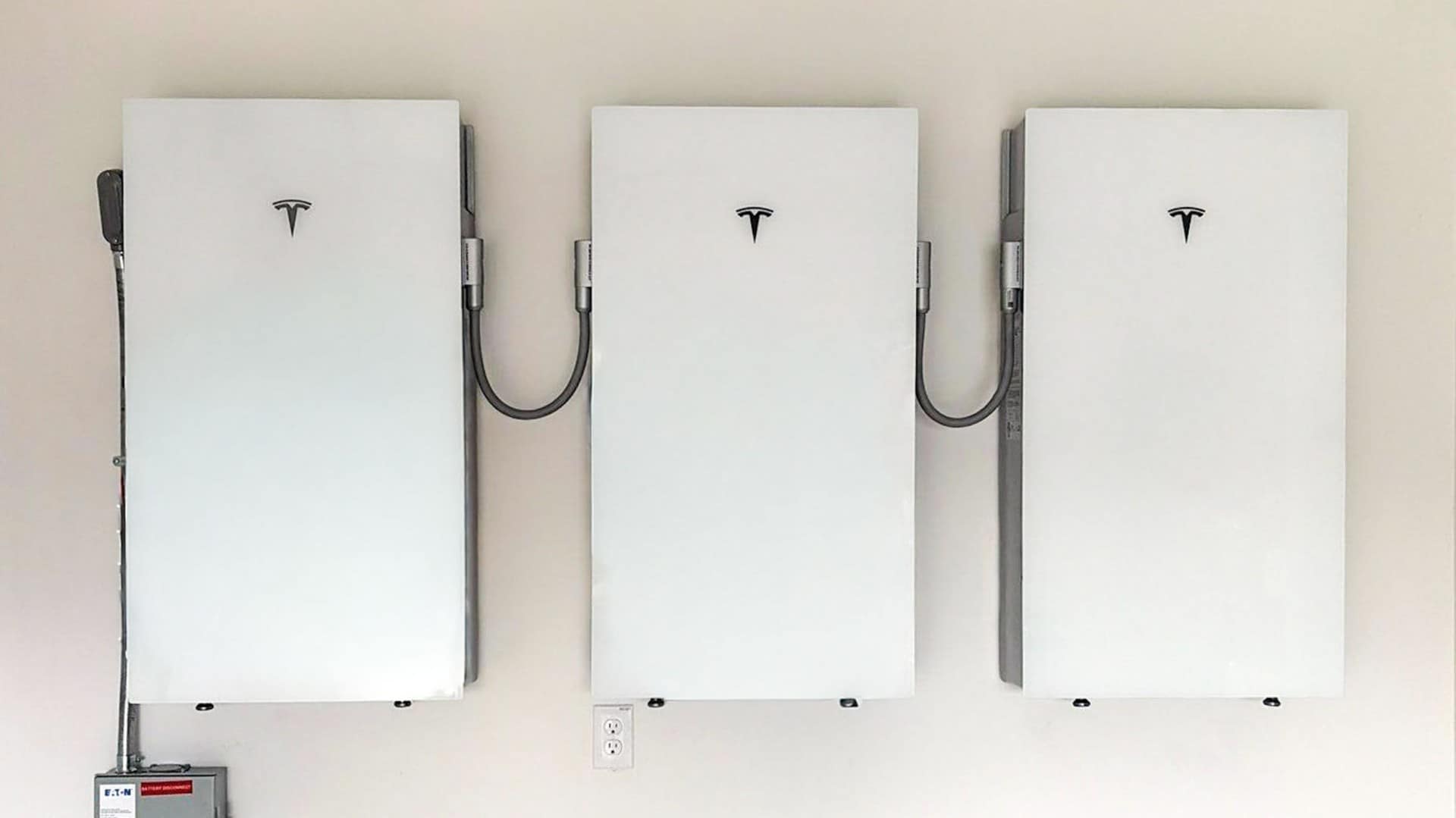 Three Tesla Powerwall batteries installed on a wall