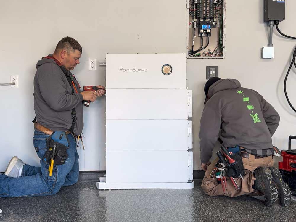 solar installers installing a battery backup