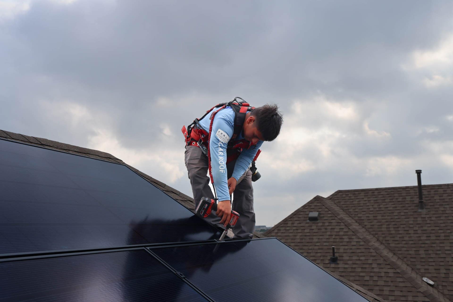 Solar technician servicing rooftop solar panels
