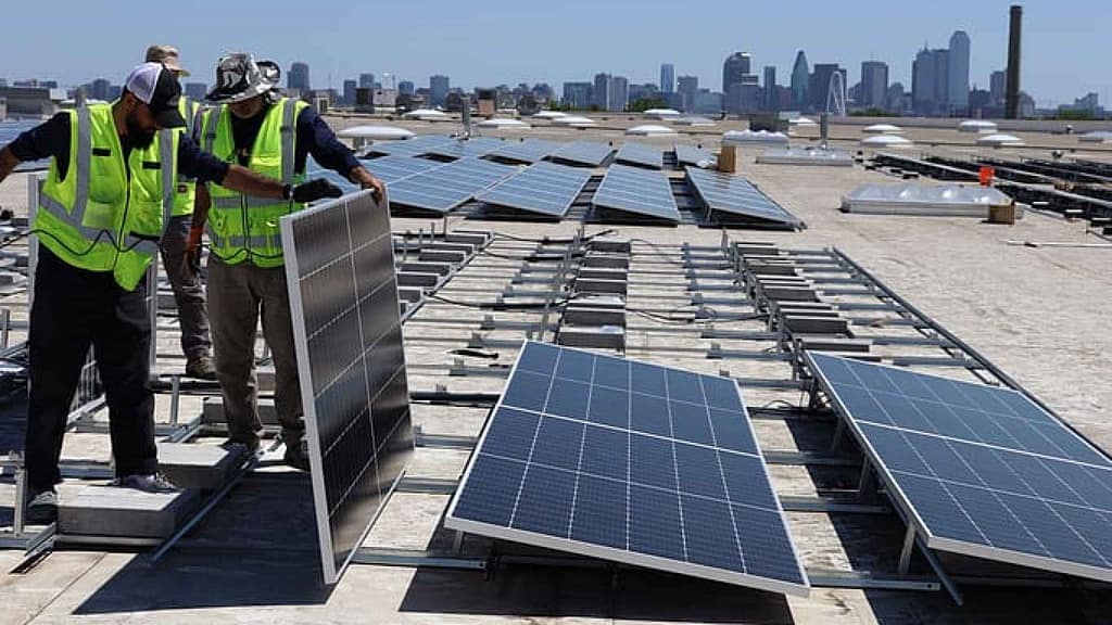 professionals installing commercial solar panels
