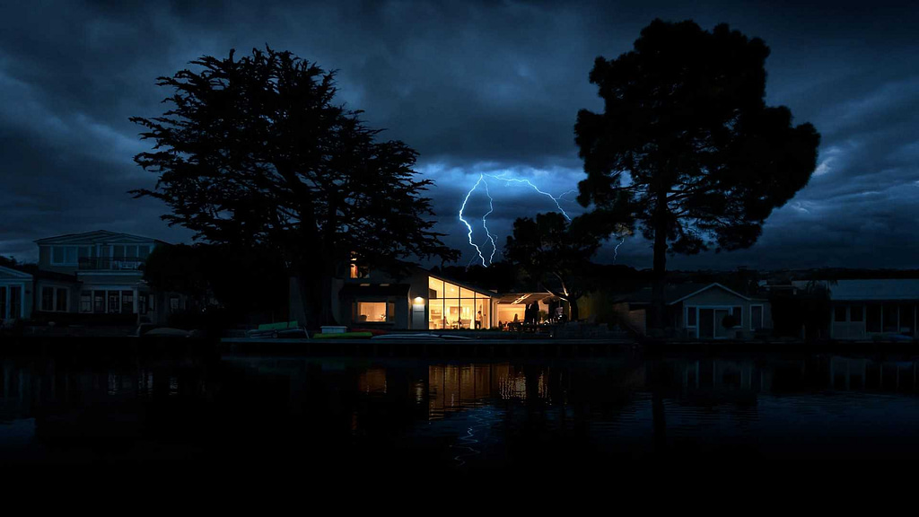 house and big trees over dark sky with lighting