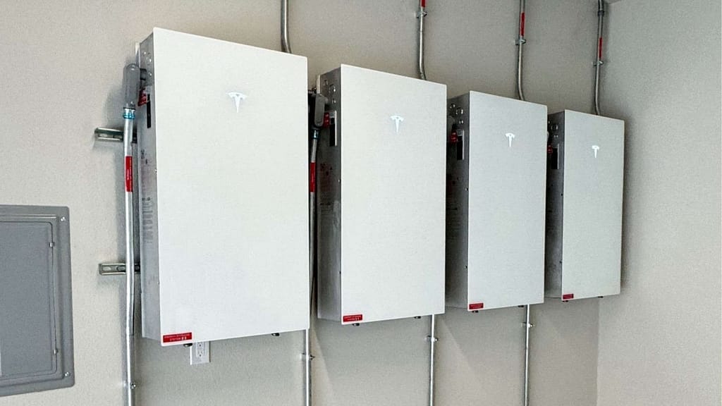 four Tesla powerwall3 units mounted in a garage