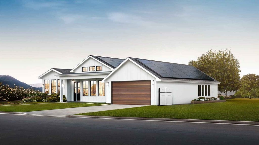 white big house with solar panels installed and tesla powerwall