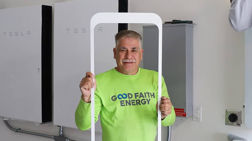 Good Faith Energy  staff holding white frame