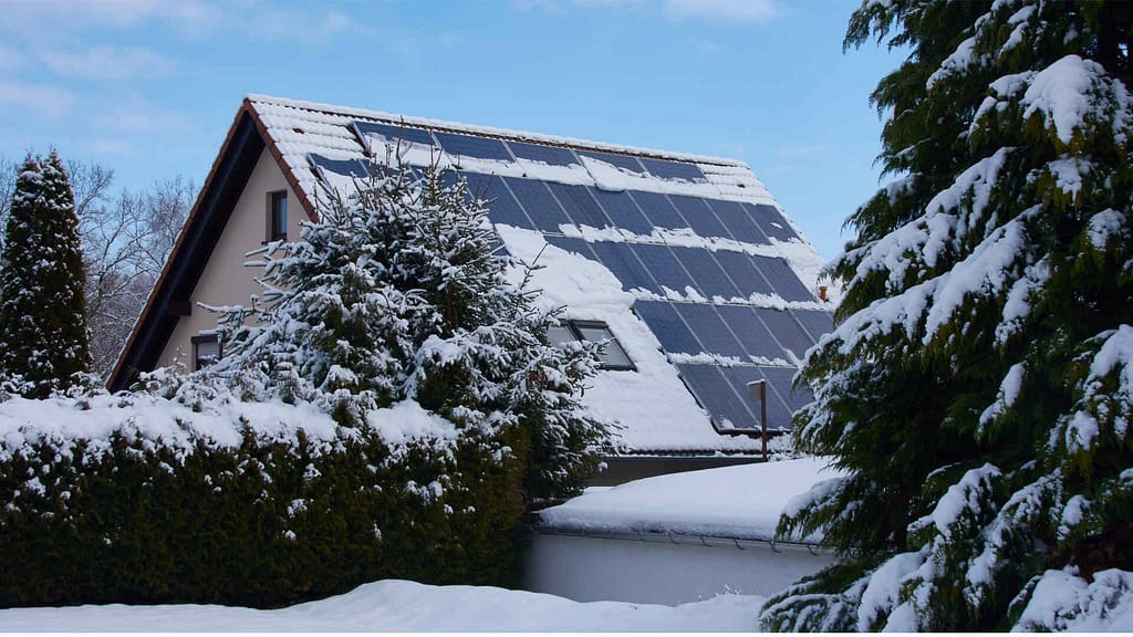 roof with solar panels covered with snow