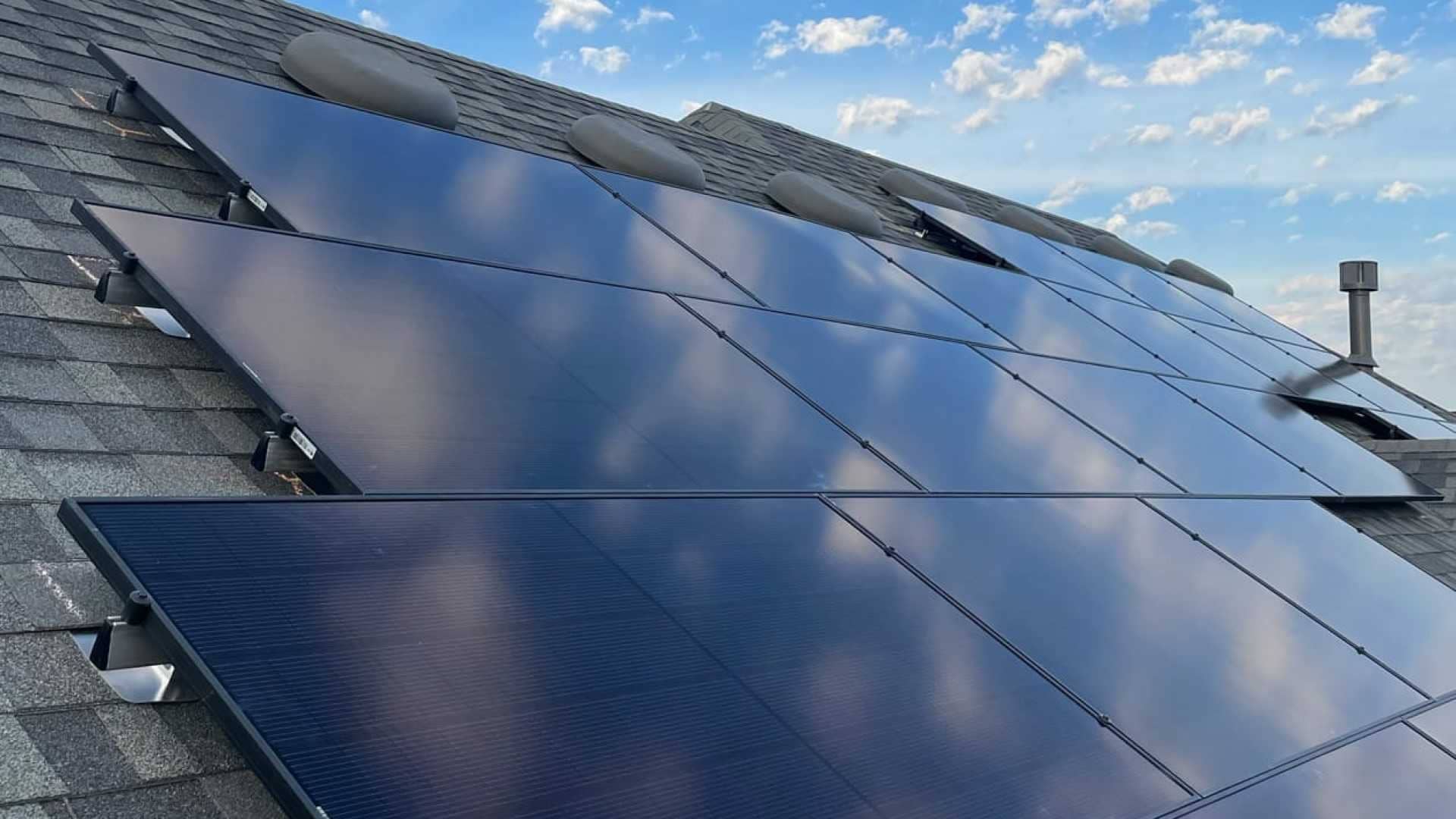 grey roof with  multiple solar panels installed